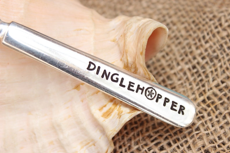 May include: A silver spoon with the words "Dinglehopper" and a starfish engraved on the handle.