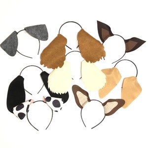 May include: A set of nine felt animal ear headbands. The headbands are in various colours and feature different animal ears, including dog, cat, and fox.