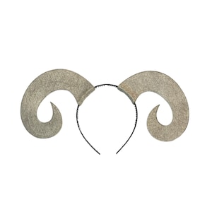 May include: A gray felt headband with two curled horns attached. The headband is black.