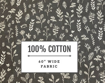 May include: A black fabric with a white floral pattern. The fabric is 100% cotton and 60 inches wide.