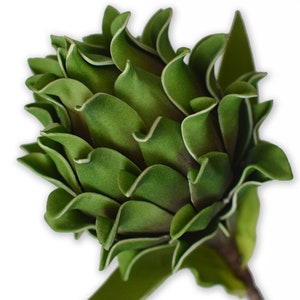 May include: A single artificial green protea flower with a long stem. The flower is made of fabric and has a realistic appearance.