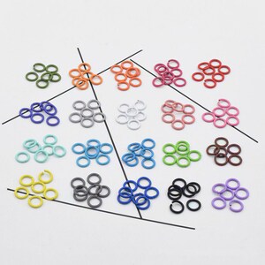 May include: Assortment of 12 different colored metal jump rings. Each color has 6 jump rings. The colors are green, orange, white, pink, light blue, lime green, brown, yellow, gray, blue, black, and purple.