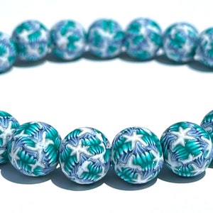 May include: A turquoise and white beaded bracelet with a starburst pattern.