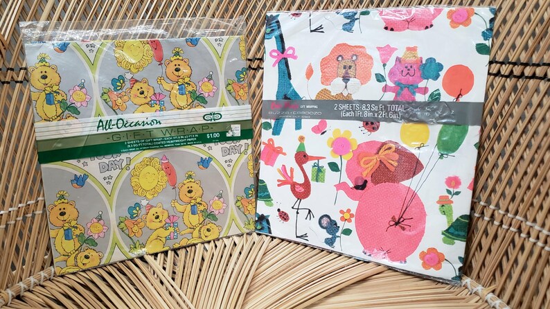 Puede incluir: Dos hojas de papel de regalo colorido con un tema de cumplea&ntilde;os. Una hoja presenta animales de dibujos animados con un fondo azul claro y el texto "All-Occasion Gift Wrap $1.00". La otra hoja presenta un elefante rosa con un fondo blanco y el texto "2 Hojas - 83 pies cuadrados Total Cada 8 pies x 2 pies (2,44 m x 0,61 m)".