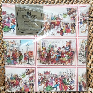 Puede incluir: Papel de regalo navide&ntilde;o vintage con una escena festiva y un borde rojo y blanco. El papel es de Norcross y presenta el texto "Merry Yuletide" y "2 sheets 20" x 26" 45.7 cm x 66 cm".