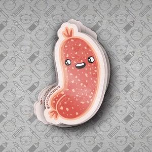 May include: A stack of stickers featuring a cartoon sausage with a smiling face. The sausage is red with white speckles and a light pink outline. The background is a gray pattern of pencils, paintbrushes, and cartoon faces.