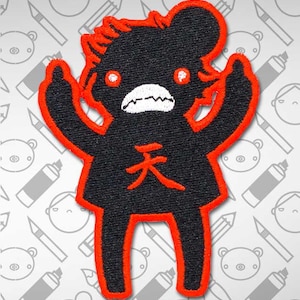 May include: Black and red embroidered patch of a cartoon character with angry eyes and a mouth with teeth. The character is wearing a red outline and has the Japanese character for "heaven" written on its chest.