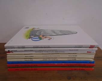 Set of 12 Hardcover French language Asterix & Tintin Books.  Mostly in good condition
