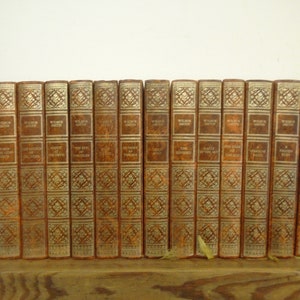 Set of 14 Wilbur Smith Vinyl covered books by Heron Books.