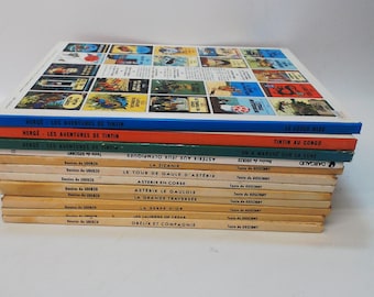 Set of 12 Hardcover French language Asterix & Tintin Books.  Mostly in good condition