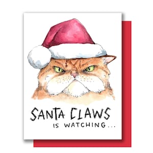 Santa Claws regarde Le chat Santa Hat Carte de Noël