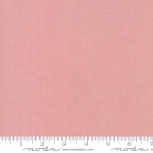 May include: A solid pink fabric with a subtle texture. The fabric is shown with a ruler measuring 17.8 cm.