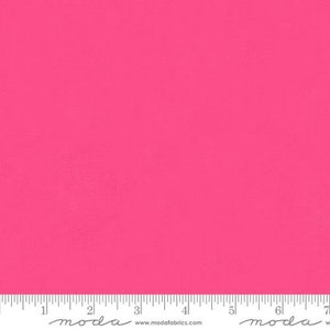 May include: A solid pink fabric swatch with the word "moda" printed in grey at the bottom.