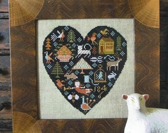 May include: Black and white cross-stitch pattern in the shape of a heart. The heart is filled with various images including a house, animals, trees, and a bird. The year 1824 is stitched in the bottom centre of the heart.