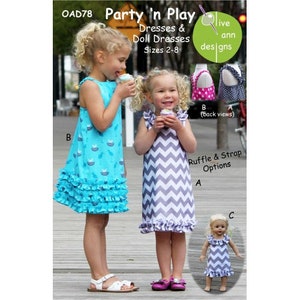 May include: A sewing pattern for dresses and doll dresses in sizes 2-8. The pattern is called "Party 'n Play" and is by "live ann designs". The image shows two girls wearing the dresses, one in a blue and white print and the other in a grey and white chevron print. A doll is also wearing a grey and white chevron dress.
