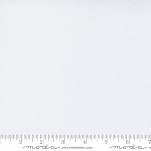 May include: A close-up of white fabric with a subtle woven texture. A ruler is at the bottom of the image, with measurements in inches. The fabric is plain and appears to be cotton or a similar material.