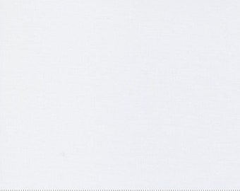 May include: A close-up of a white fabric with a subtle woven texture. A ruler is at the bottom of the image, with measurements in inches. The fabric is plain and appears to be cotton or a similar material.