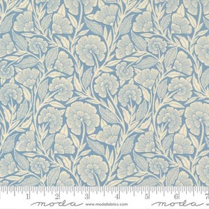 May include: A blue and white floral fabric with a repeating pattern of stylised flowers and leaves. The fabric is shown with a ruler for scale.