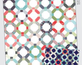 May include: A quilt pattern called "Cheerios" by Thimble Blossoms, featuring a repeating pattern of octagons and circles in shades of blue, green, red, and white on a white background.