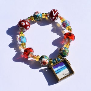 Springtime beaded bracelet with double sided (changable) charm