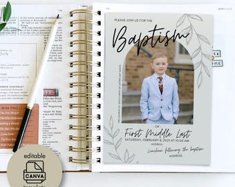 May include: A baptism invitation card with a photo of a young boy in a light blue suit. The card has the word "Baptism" in elegant script, with details including the date, time, and address. The card is set on a spiral-bound notebook.