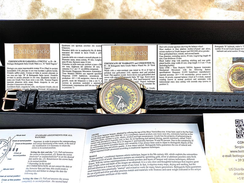May include: A gold-plated Bottegando watch with a black leather strap. The watch has a distinctive face design and is displayed in a black box with paperwork. The watch has a 40 mm case diameter.
