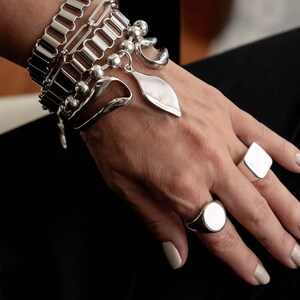 Layered statement chain bracelets and bangle, Stacked chunky stainless steel bracelets and hammered bangle.