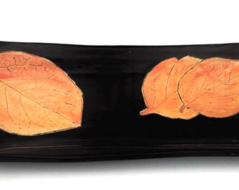 Rectangular black and persimmon tray with leaves.