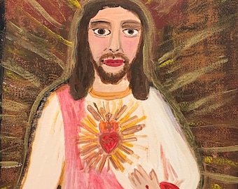 May include: A folk art painting of a figure with long brown hair and a beard, wearing a white robe with a pink sash. A golden halo surrounds the figure's head, and a heart with flames is on the chest. The background is a mix of red and gold.