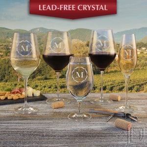 May include: Set of five clear glass wine glasses with a lead-free crystal design. Each glass features a monogrammed letter "M" etched into the glass.