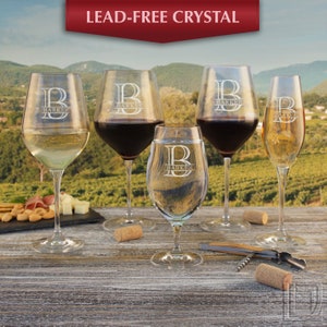 May include: Set of five lead-free crystal wine glasses with a personalized monogram and the name "Barker" etched on each glass. The glasses are arranged on a wooden table with wine corks and a corkscrew.