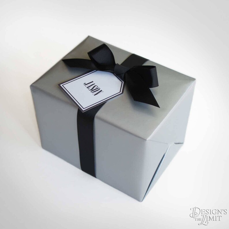 May include: A silver gift box with a black ribbon and a white gift tag that says "Jason".