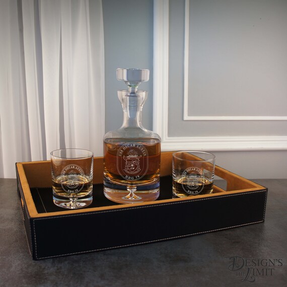 A hand-engraved glass decanter with personalized monogram or design — the kind of barware that looks inherited, not ordered online.