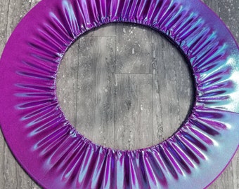 May include: A purple and blue iridescent fabric hoop for exercise or dance. The hoop is made of a soft, flexible material and has a smooth, shiny finish.