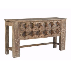 May include: A weathered, wooden console table with intricate carved details. The table features a rectangular top and a lower shelf, supported by sturdy legs. The front of the table is adorned with a repeating pattern of carved squares and rectangles, adding a rustic charm.