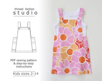 May include: A sewing pattern for a kids' overall dress with a floral print. The pattern includes step-by-step instructions and is available in sizes 2-14.