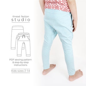 May include: A PDF sewing pattern for children's trousers, sizes 2-14. The pattern includes step-by-step instructions. The image shows a line drawing of the trousers and a child wearing a pair of light blue trousers.