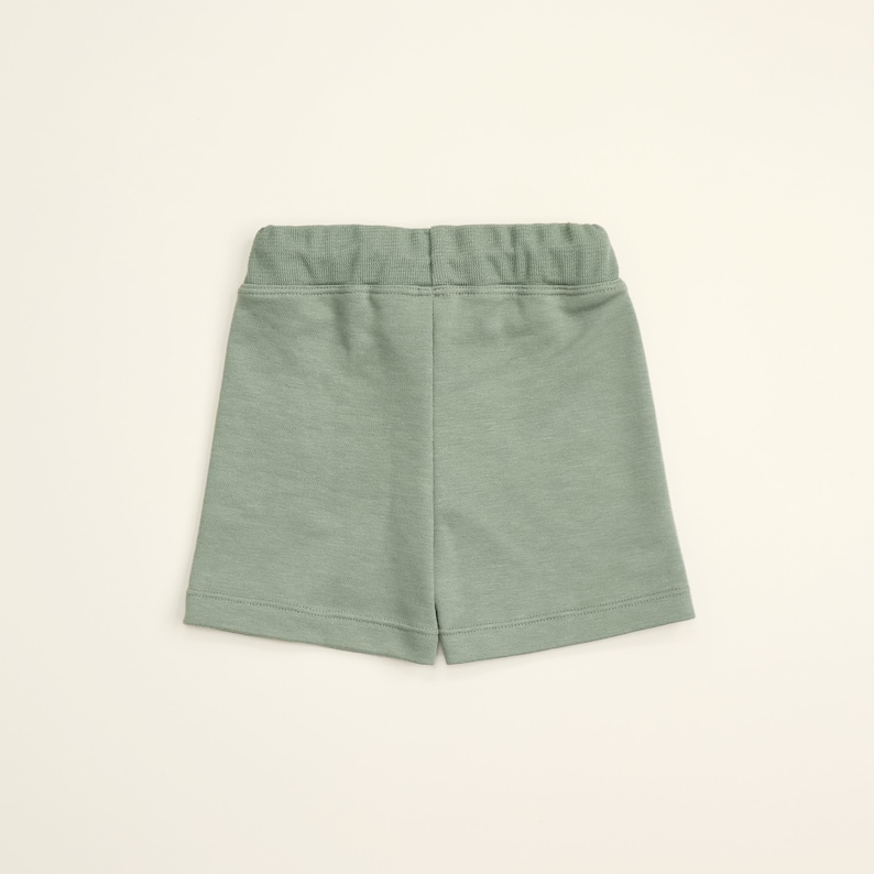 May include: A pair of light green shorts with an elastic waistband.