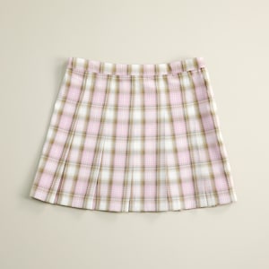 May include: A pleated skirt with a pink and brown plaid pattern.