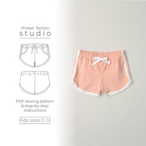 May include: A sewing pattern for kids shorts with a white drawstring and white trim. The pattern includes instructions for sizes 2-14. "thread faction studio" is printed on the pattern.