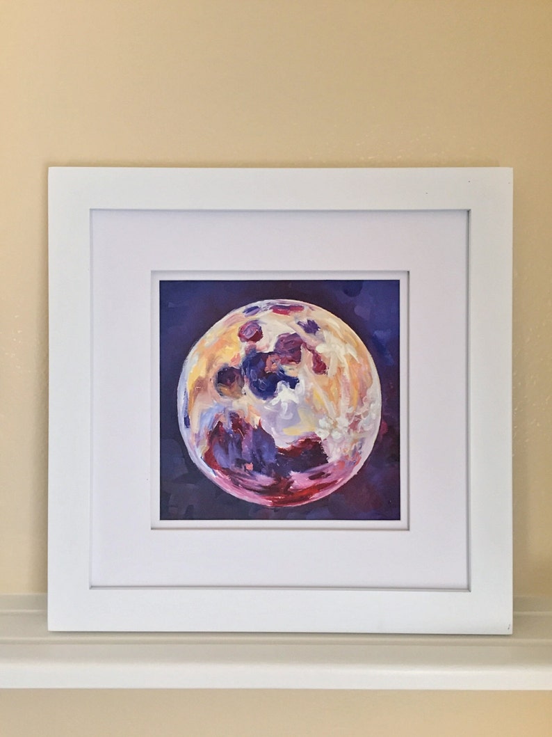 May include: A framed painting of a colorful moon with shades of purple, yellow, and red against a dark purple background.
