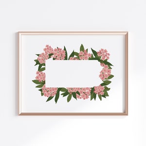 May include: A framed print with a white background and a border of pink flowers and green leaves.