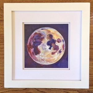 May include: A framed painting of a full moon with a purple, yellow, and white color scheme. The moon is painted in a realistic style with visible craters and shadows.