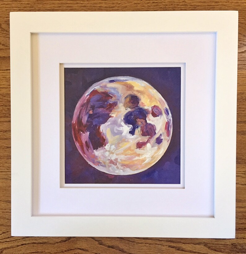 May include: A framed painting of a full moon with a purple, yellow, and white color scheme. The moon is painted in a realistic style with visible craters and shadows.