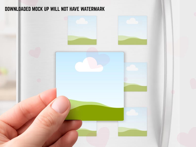 May include: A hand holding a square magnet with a landscape design of a blue sky, white cloud, and green hills. Several similar magnets are attached to a white surface. The text "DOWNLOADED MOCK UP WILL NOT HAVE WATERMARK" is at the top.