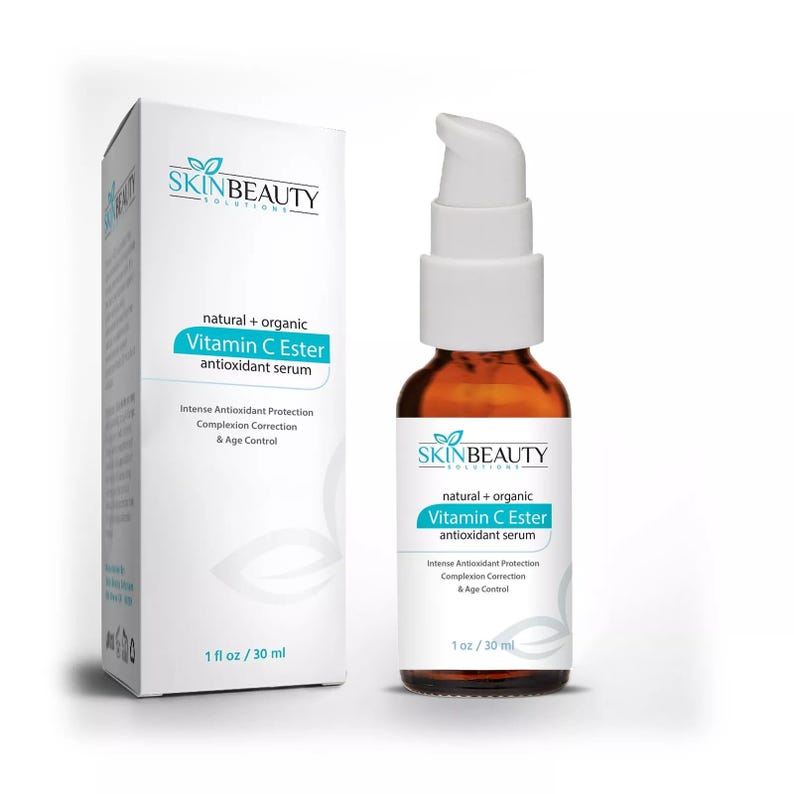 May include: A 30 ml bottle of SkinBeauty Solutions natural and organic Vitamin C Ester antioxidant serum. The bottle is amber glass with a white pump top. The label is white with blue and green accents. The text on the label reads "natural + organic Vitamin C Ester antioxidant serum" and "Intense Antioxidant Protection Complexion Correction & Age Control".
