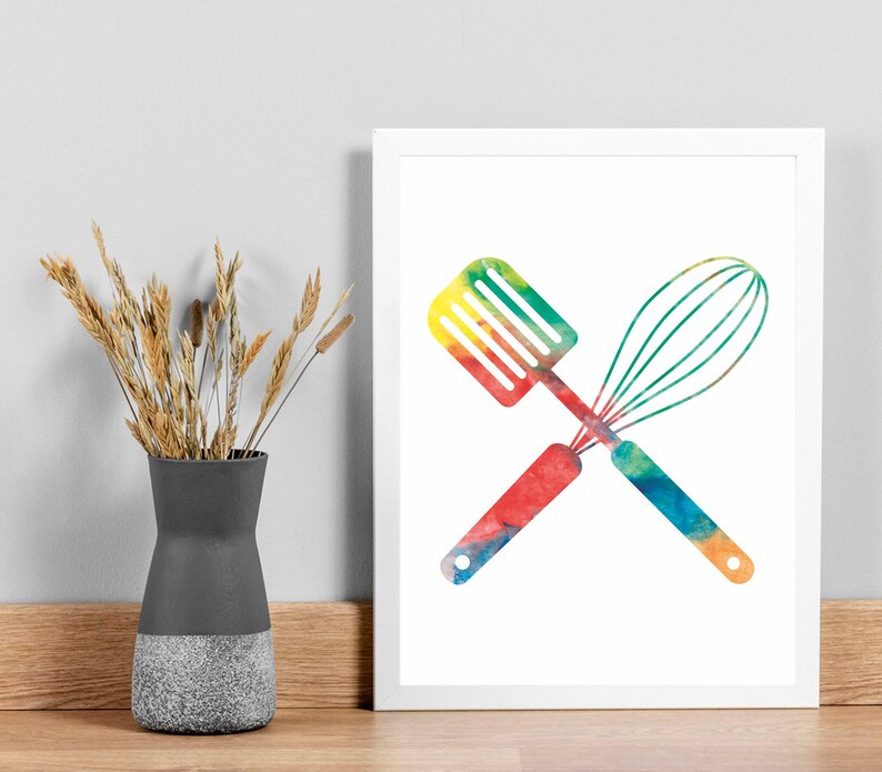 May include: A watercolor illustration of a spatula and whisk crossed over each other. The utensils are painted in a rainbow of colors.