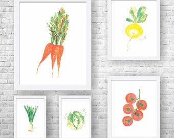 May include: Five framed watercolor paintings of different vegetables. The paintings are on a white brick wall. The vegetables include carrots, a turnip, a head of cabbage, a bunch of green onions, and a cluster of red tomatoes.