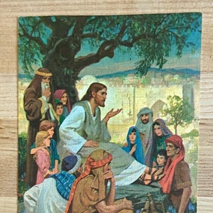 May include: A vintage postcard with a religious theme. It features a painting of Jesus teaching a group of people under a tree. The text on the postcard reads "It's Rally Day Next Sunday! Be Sure to Come!" and "Teach me thy way, O Lord." - Psalm 86:11