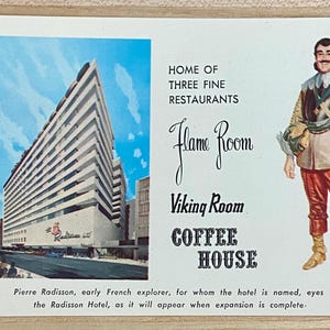 May include: A vintage postcard featuring a photo of a modern hotel building with the text "Home of Three Fine Restaurants" and the names of three restaurants: "Flame Room", "Viking Room", and "Coffee House". The postcard also features a drawing of a man in a historical costume.
